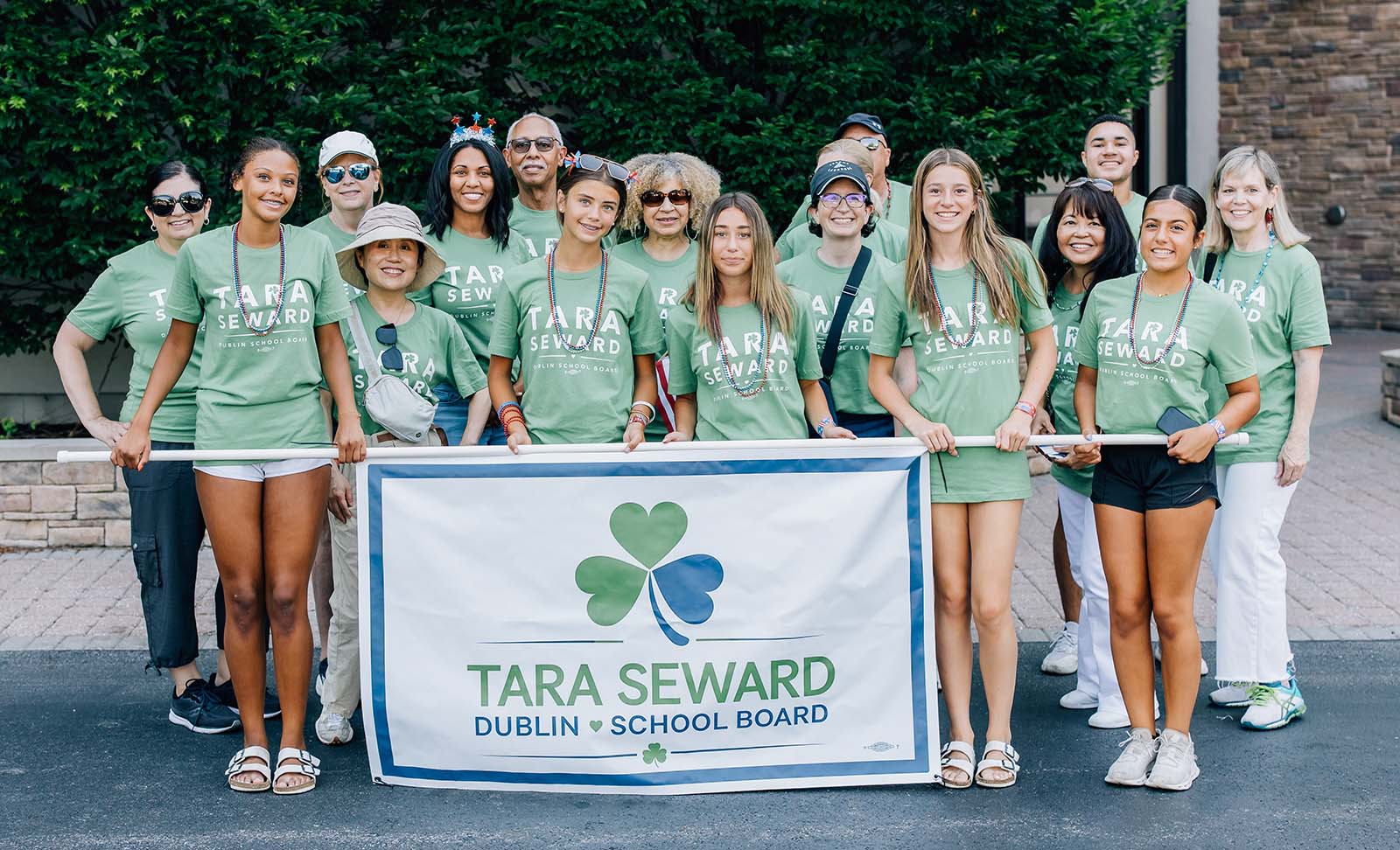 Tara Seward holding campaign sign alongside family and friends at Dublin 4th of July Parade 2025